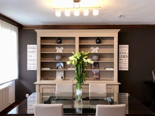 a dining room with a glass table with a vase of flowers at Mundo-Abeona in Tudela