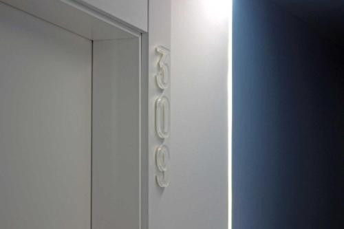 a white cabinet with silver handles on a wall at Rocatel in Canet de Mar