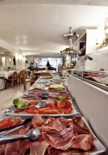 a buffet line with many different types of food at Hotel Maria Luisa in Burgos