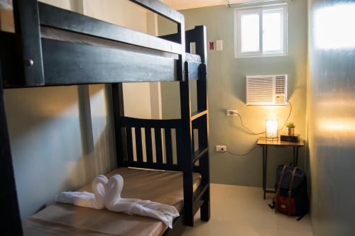 a bedroom with a bunk bed with a ladder at ParmView Inn in Legazpi