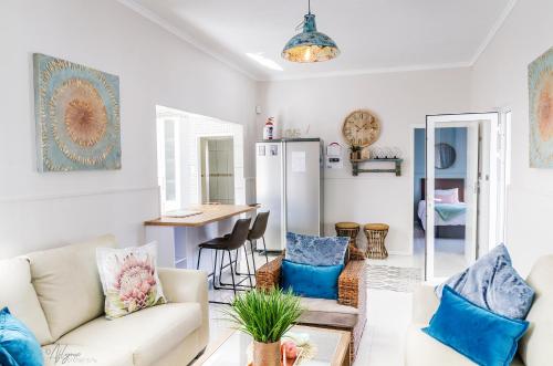 ein Wohnzimmer mit einem Sofa und einem Tisch in der Unterkunft Mahdi Cottage in Swakopmund
