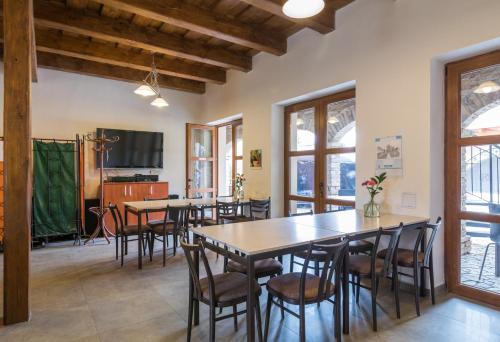 a dining room with tables and chairs and windows at Apartmány Fojtova studna in Sedlec