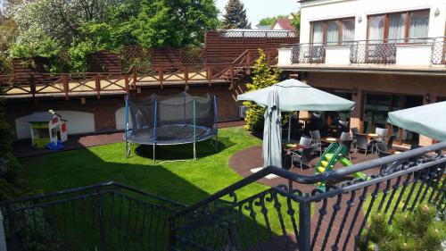 a backyard with a playground with a trampoline at Hotel Rigga in Władysławowo