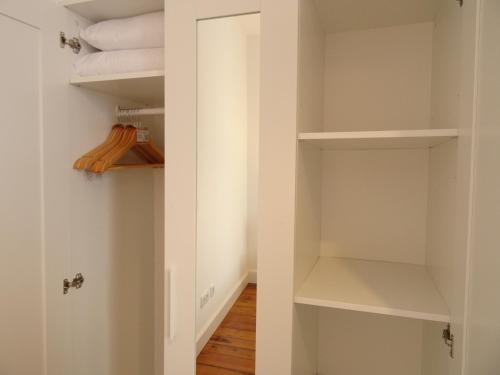 a closet with white walls and wooden floors at Museum House in Funchal