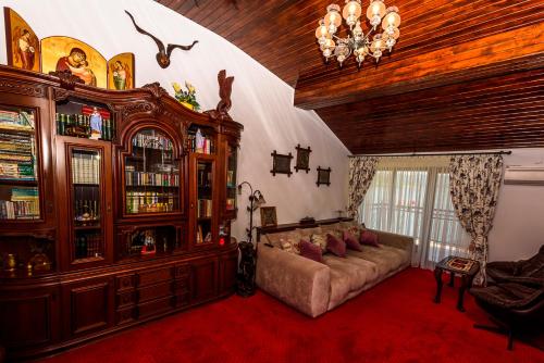a living room with a couch and a large wooden cabinet at Casa Andrei in Orşova