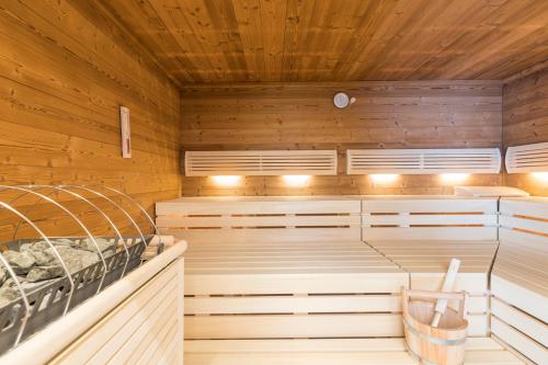 a sauna with wooden walls and wooden ceilings at OFENTÜRL alpine living in Flachau
