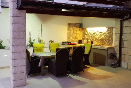 an outdoor kitchen with a table and chairs at Old Town & Sea View in Dubrovnik