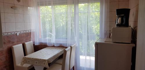 a kitchen with a table and a window at Barbara Vendégház in Balatonfüred