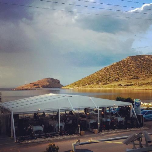 a white tent in front of a body of water at Sea Sight Boutique Hotel in Porto Rafti