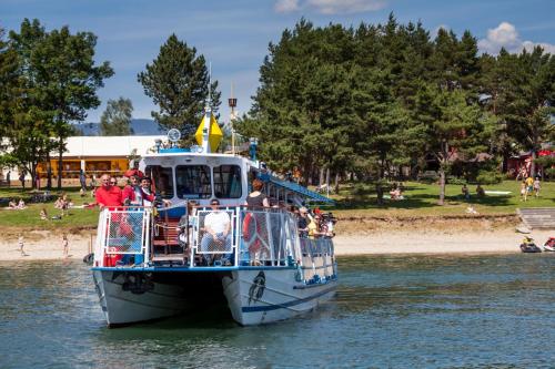 a group of people on a boat in the water at Chalupa na Liptove - Chata pri Mare in Liptovský Trnovec