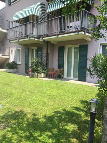 an apartment building with a balcony and a lawn at Hotel Clodia - Adults Only in Sirmione