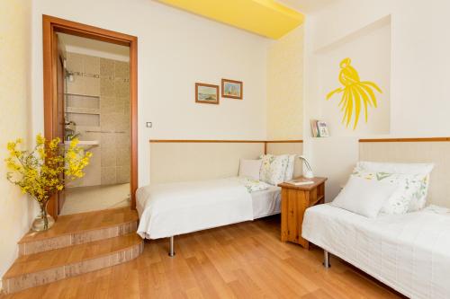 a room with two beds and a vase of flowers at Pštrossova Vila - u klášterní zahrady in Bechyně