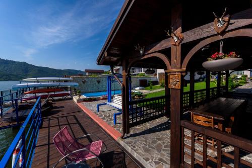 a deck of a house with a pool and a boat at Casa Andrei in Orşova
