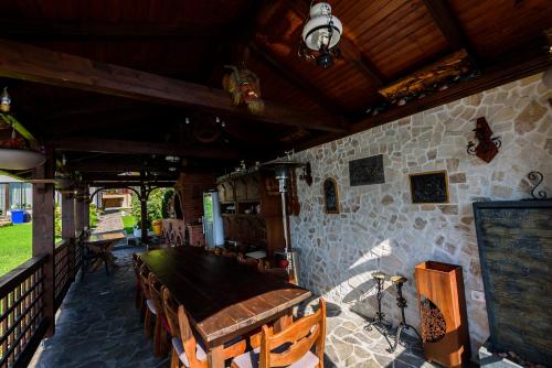 a dining room with a wooden table and chairs at Casa Andrei in Orşova
