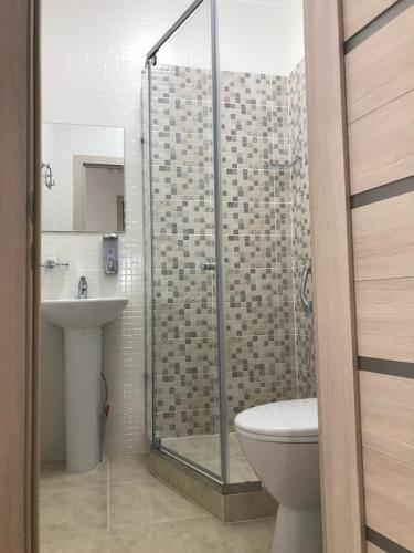 a bathroom with a shower and a toilet and a sink at Prospect in Astana