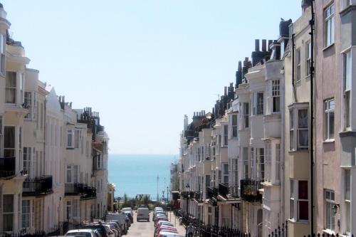 a street lined with buildings with cars parked on the street at Hudsons in Brighton & Hove