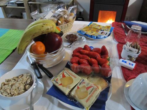 a table with a bunch of food and fruit on it at B&B da NINA in Sabbioneta