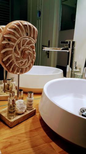 a bathroom with a white tub and a sink at Casa Al Porto Antico in Piran