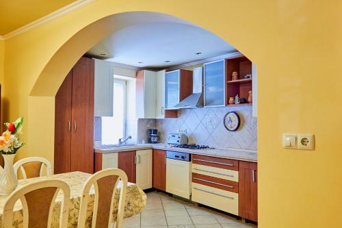 a kitchen with an archway leading to a dining room at King Arthur Panzió in Baja