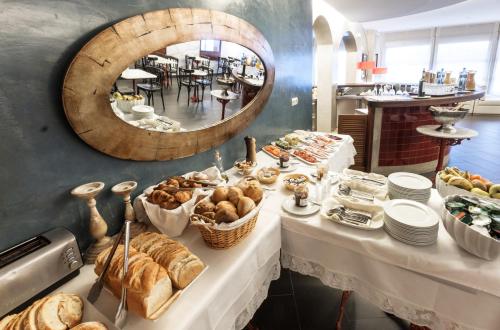 a table with a bunch of bread and pastries at Hotel Carmen in Roses