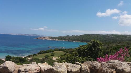 a view of the ocean from a rock wall at Appartamento Fronte Mare in Santa Teresa Gallura