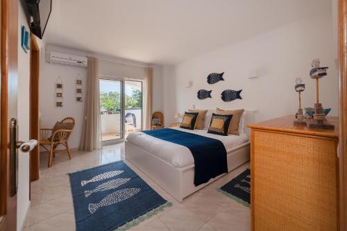 a bedroom with a large bed and a window at Sunflower Villa - Blue Sea in Albufeira