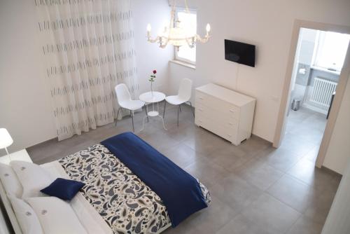 a bedroom with a bed and a table and a tv at B&B La Veranda di Gio in Torrimpietra