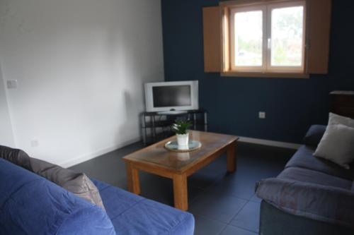 a living room with a couch and a coffee table at Casa Moderna Proxima da Praia in Santa Catarina