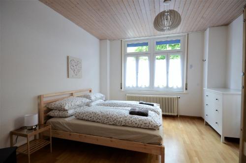 a bedroom with two beds and a window at Interlaken Central 1 in Interlaken