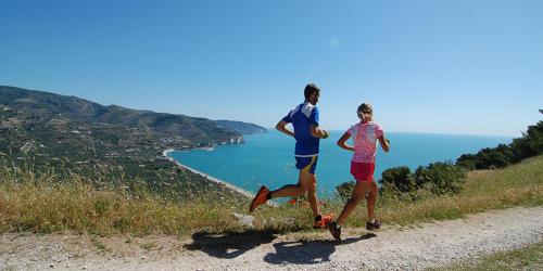 a man and a woman running down a hill at Casa MARESOLE in Mattinata