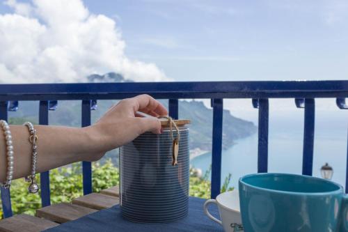 a hand holding a can on a table at Angiem Holiday House Ravello in Ravello
