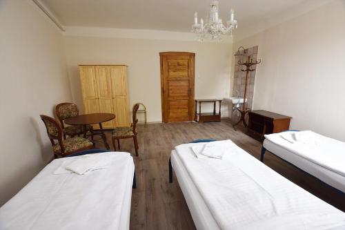 Postel nebo postele na pokoji v ubytování Penzion Klášter
