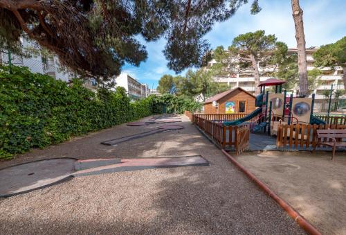 a park with a playground with a slide at Golden Port Salou & Spa in Salou