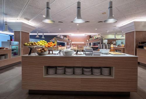 a kitchen with a counter with bowls of fruit at Golden Port Salou & Spa in Salou