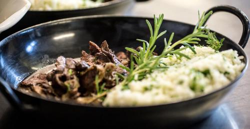 a black bowl filled with food on a table at Weingut Essgut Schlafgut Sabathihof-Dillinger in Glanz an der Weinstraße 