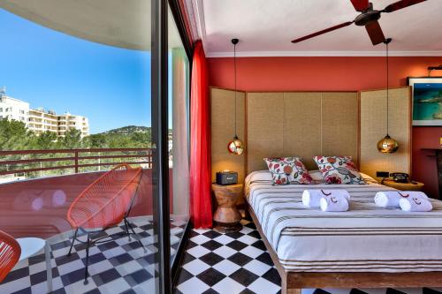 a bedroom with a bed and a balcony at Cubanito Ibiza in San Antonio