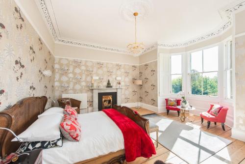 a bedroom with a bed and a fireplace at 3 Eskbank Terrace in Dalkeith