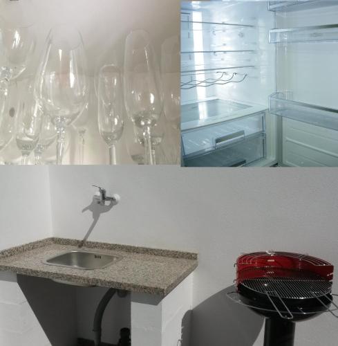 a bunch of wine glasses on a wall with a sink at ÁTICO Carihuela-PARKING gratis-WIFI in Torremolinos