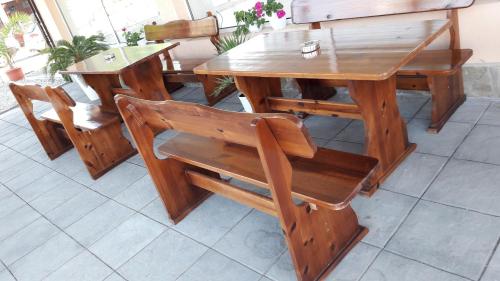 a wooden table and chairs sitting next to a table at Stephanovy Guest House in Sozopol