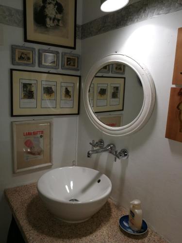 a bathroom with a white sink and a mirror at Sa Rezzetta in Golfo Aranci