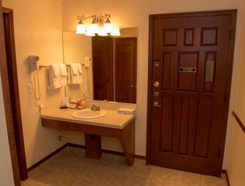 a bathroom with a sink and a mirror at Hilltop Inn Broomfield Denver in Broomfield