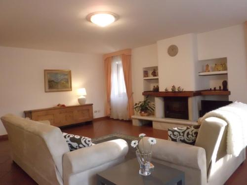 a living room with two couches and a fireplace at Affittacamere Ca' Fattorini in Baceno