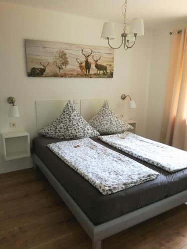 a bedroom with two beds and a painting on the wall at Schwarzwaldhaus Markus in Freudenstadt