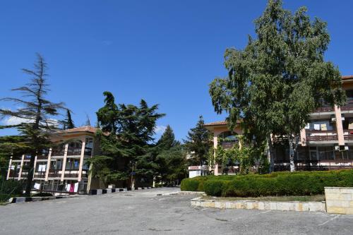 an empty parking lot in front of a building at Ahilea Hotel - Free Pool Access in Balchik