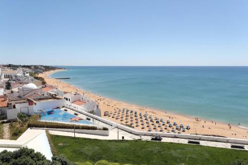 a view of a beach with umbrellas and the ocean at Vila Sao Vicente Boutique (Adults Only) in Albufeira