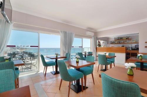 a dining room with a view of the ocean at Vila Sao Vicente Boutique (Adults Only) in Albufeira