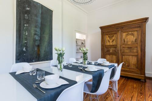 une salle à manger avec une table et des chaises blanches dans l'établissement Chambre d'hôtes Du côté des remparts, à Wissembourg