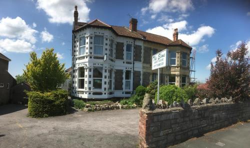 a large house with a sign in front of it at The Elms Guest House Bristol in Bristol