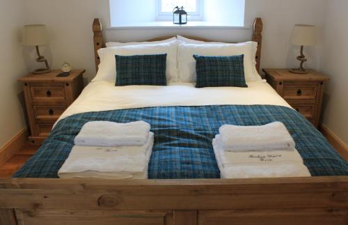 a bedroom with a bed with two towels on it at The Annex at Borlum House in Reay