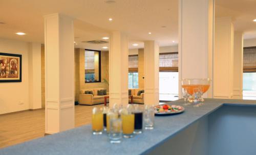 a bar with glasses and a plate of food on a counter at Centrum Hotel - City Center in Nicosia